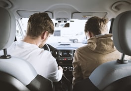 Instructor in the passenger seat beside a learner before a practice drive