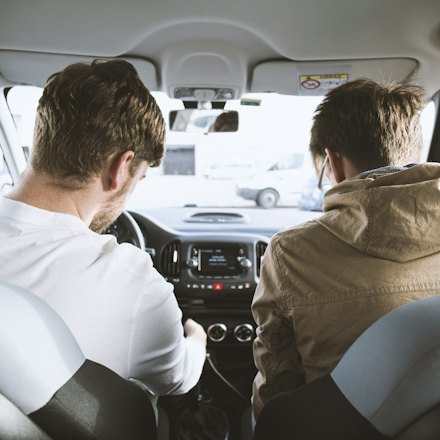 Instructor in the passenger seat beside a learner before a practice drive