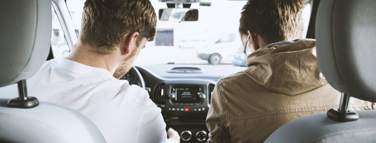 Instructor in the passenger seat beside a learner before a practice drive
