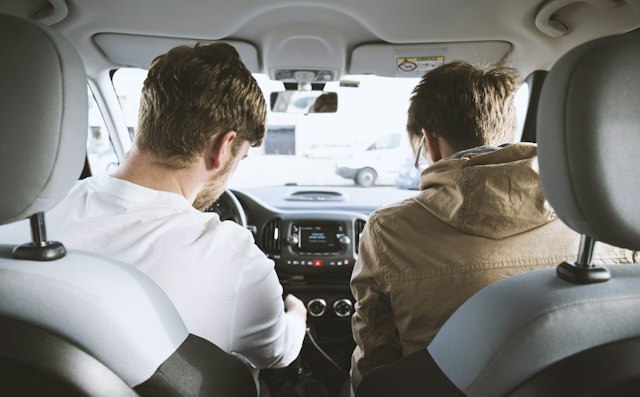 Instructor in the passenger seat beside a learner before a practice drive